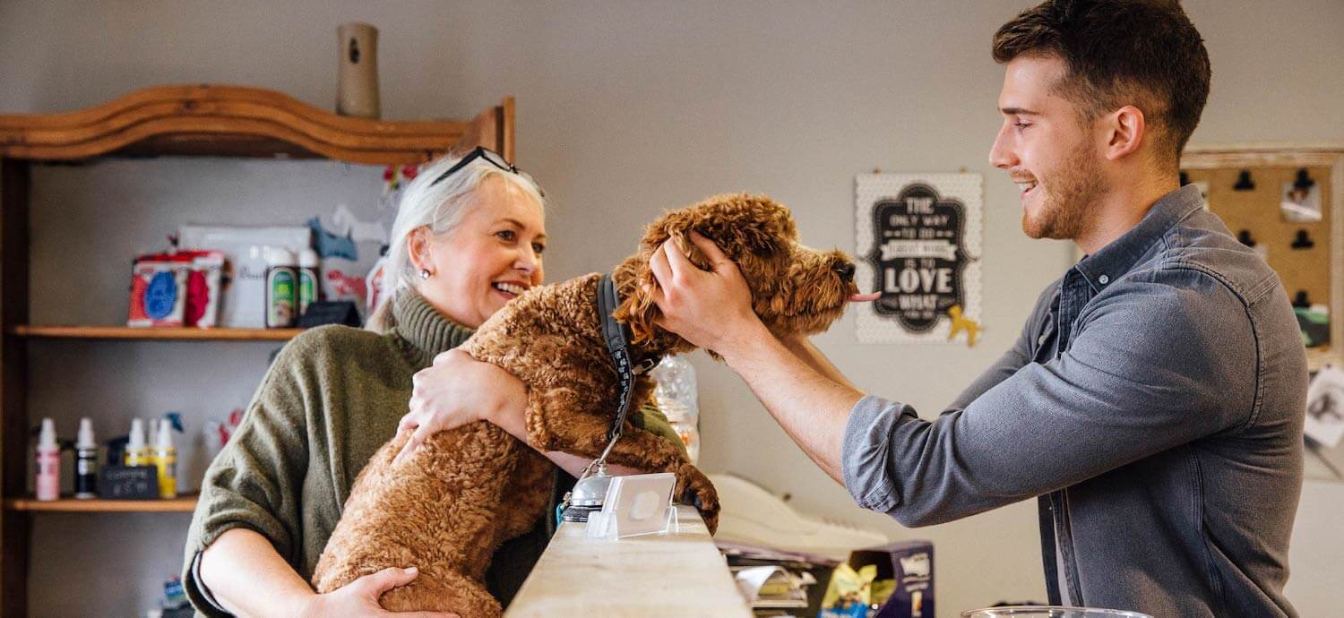 Person completing a payment at a pet groomer