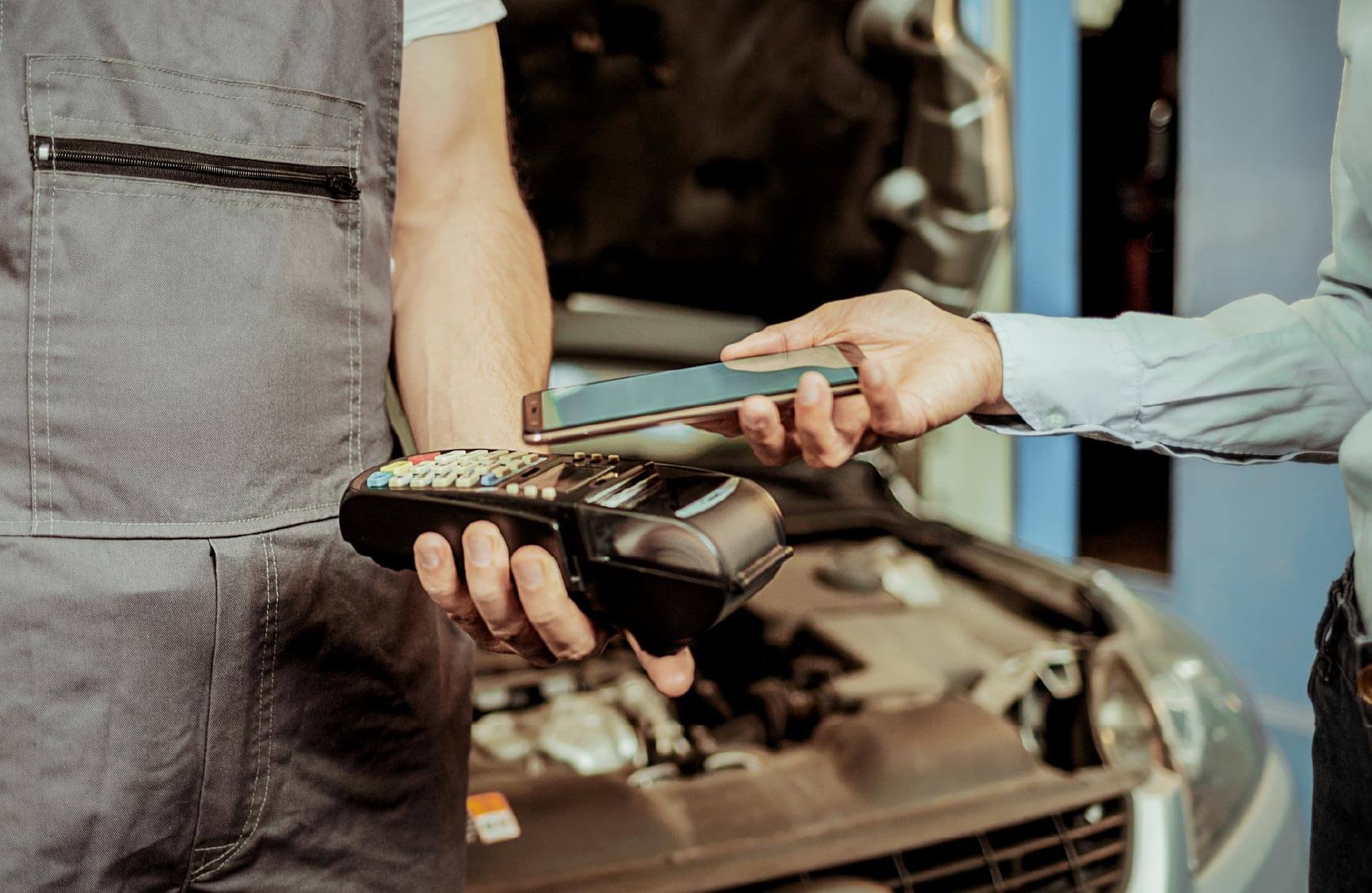 Person completing payment for automotive repair