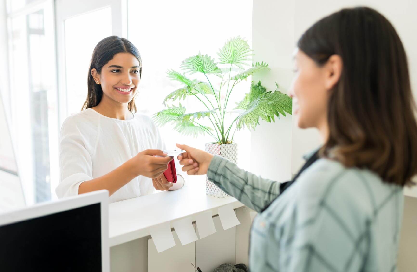 Person paying at chiropractic office