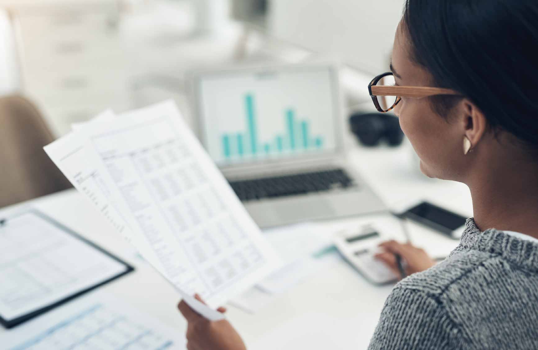 Woman looking at data on paper